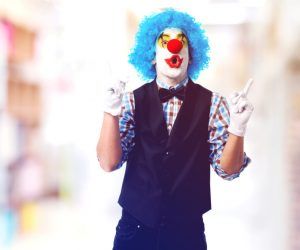 portrait of a clown smiling over white background